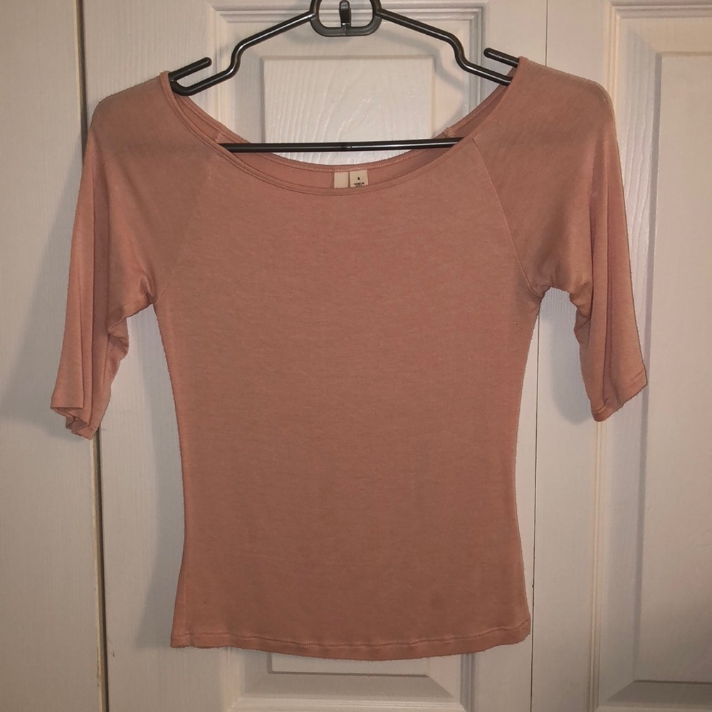 Form fitting light pink shirt